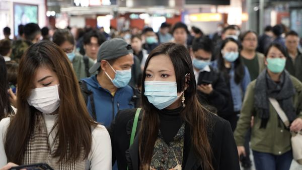 Passengers wear masks to prevent an outbreak of a new coronavirus in a subway station, in Hong Kong, Wednesday, Jan. 22, 2020 - Sputnik International