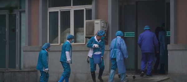 Hospital staff wash the emergency entrance of Wuhan Medical Treatment Center, where some infected with a new virus are being treated, in Wuhan, China, Wednesday, Jan. 22, 2020. - Sputnik International