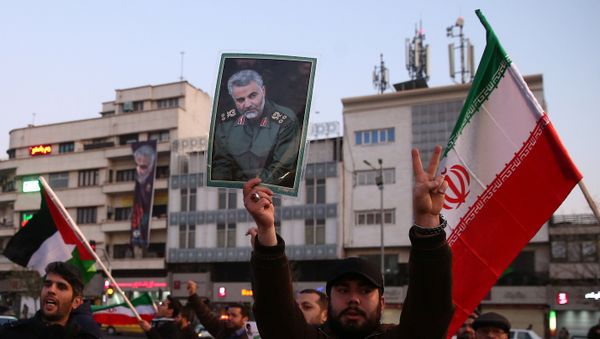 A man holds a picture of late Iranian Major-General Qassem Soleimani, as people celebrate in the street after Iran launched missiles at U.S.-led forces in Iraq, in Tehran, Iran A man holds a picture of late Iranian Major-General Qassem Soleimani, as people celebrate in the street after Iran launched missiles at U.S.-led forces in Iraq, in Tehran, Iran - Sputnik International