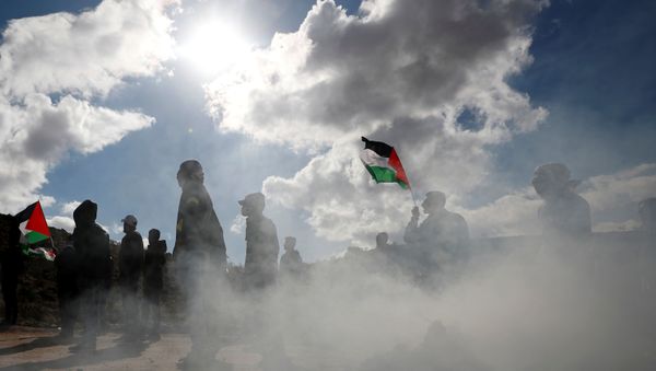Palestinian demonstrators take part in an anti-Israel protest in al-Mughayyir village near Ramallah, in the Israeli-occupied West Bank, January 3, 2020.  - Sputnik International