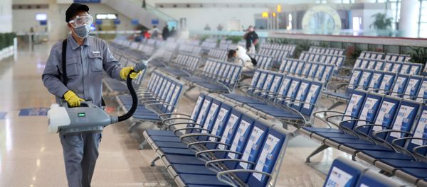 Workers in protective mask disinfects a waiting hall following the outbreak of a new coronavirus at the Nanjing Railway Station, in Nanjing - Sputnik International