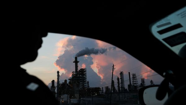A police officer drives past a refinery in the industrial east end in Pasadena, Texas, U.S., September 18, 2018. REUTERS - Sputnik International