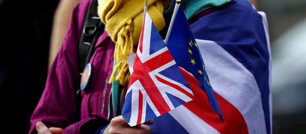 An anti-Brexit demonstrator holds British and European flags during a protest in front of the European Parliament in Brussels, Belgium January 30, 2020. An anti-Brexit demonstrator holds British and European flags during a protest in front of the European Parliament in Brussels, Belgium January 30, 2020. - Sputnik International