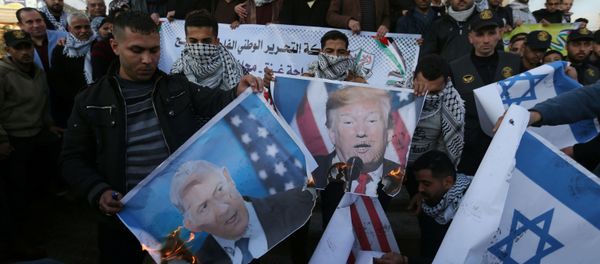 Palestinian demonstrators burn pictures depicting U.S. President Donald Trump and Israeli Prime Minister Benjamin Netanyahu, and repsentations of U.S and Israeli flags during a protest against the U.S. President Donald Trump's Middle East peace plan, in the southern Gaza Strip January 29, 2020 Palestinian demonstrators burn pictures depicting U.S. President Donald Trump and Israeli Prime Minister Benjamin Netanyahu, and repsentations of U.S and Israeli flags during a protest against the U.S. President Donald Trump's Middle East peace plan, in the southern Gaza Strip January 29, 2020 - Sputnik International