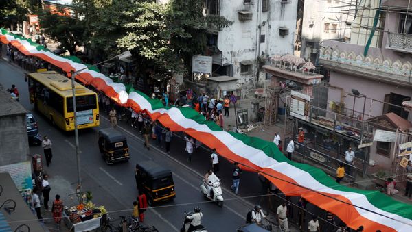 People hold an Indian national flag during a unity rally in Mumbai, India, January 24, 2020 People hold an Indian national flag during a unity rally in Mumbai, India, January 24, 2020 - Sputnik International