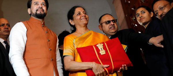 India's Finance Minister Nirmala Sitharaman is flanked by junior Finance Minister Anurag Thakur as she arrives to present the budget in Parliament in New Delhi, India, February 1, 2020. India's Finance Minister Nirmala Sitharaman is flanked by junior Finance Minister Anurag Thakur as she arrives to present the budget in Parliament in New Delhi, India, February 1, 2020. - Sputnik International