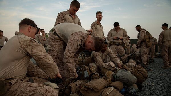In this photo provided by U.S. Department of Defense, U.S. Marines assigned to Special Purpose Marine Air-Ground Task Force-Crisis Response-Central Command (SPMAGTF-CR-CC) 19.2, prepare to deploy from Kuwait in support of a crisis response mission, Tuesday, Dec. 31, 2019 - Sputnik International