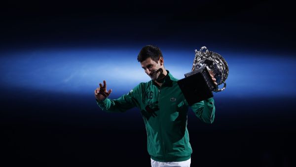 Tennis - Australian Open - Men's Singles Final - Melbourne Park, Melbourne, Australia - February 3, 2020. Serbia's Novak Djokovic celebrates with the trophy after winning his match against Austria's Dominic Thiem Tennis - Australian Open - Men's Singles Final - Melbourne Park, Melbourne, Australia - February 3, 2020. Serbia's Novak Djokovic celebrates with the trophy after winning his match against Austria's Dominic Thiem - Sputnik International