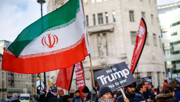 A demonstrator holds an Iranian flags while attending a protest to oppose the threat of war with Iran, in London, Britain January 11, 2020.   - Sputnik International