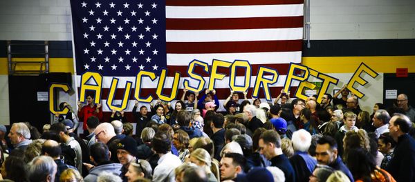 Attendees hold letters that read CAUCUS FOR PETE before Democratic presidential candidate former South Bend, Ind., Mayor Pete Buttigieg arrives to speak during campaign event at Northwest Junior High, Sunday, Feb. 2, 2020, in Coralville, Iowa. - Sputnik International