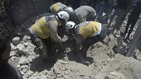 This photo provided by the Syrian Civil Defense White Helmets, which has been authenticated based on its contents and other AP reporting, shows Syrian White Helmet civil defense workers pull out a victim from under the rubble of a destroyed building that hit by a Syrian government airstrike, in the northern town of Ariha, in Idlib province, Syria, Friday, July 12, 2019 - Sputnik International