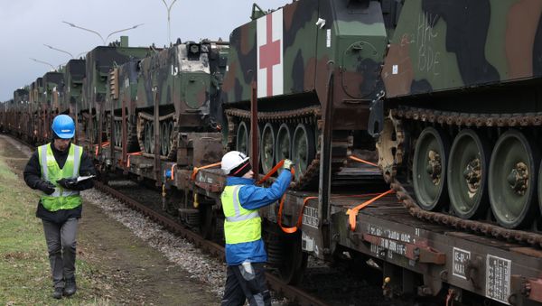 U.S. Army troop carrier vehicles get secured and tagged onto railcars as part of an Army Prepositioned Stock (APS) movement at Coleman Barracks in Mannheim, Germany, Jan. 28, 2019 - Sputnik International