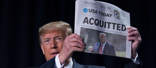 President Donald Trump holds up a newspaper with the headline that reads ACQUITTED at the 68th annual National Prayer Breakfast, at the Washington Hilton, Thursday, Feb. 6, 2020, in Washington. - Sputnik International