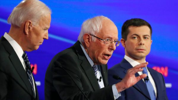 Democratic 2020 U.S. presidential candidates former Vice President Joe Biden listens to Senator Bernie Sanders as former South Bend Mayor Pete Buttigieg looks on in the seventh Democratic 2020 presidential debate at Drake University in Des Moines - Sputnik International