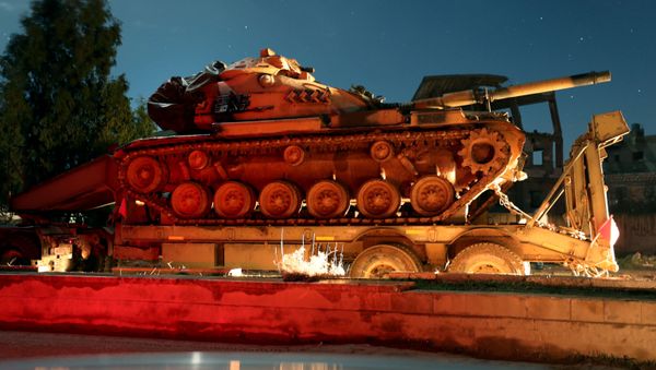 A Turkish military convoy of tanks and armoured vehicles passes through the town of Binnish reportedly heading toward the city of Idlib in Syria’s northwestern province of the same name, on February 7, 2020 - Sputnik International