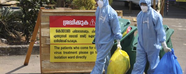 Indian workers walk with garbage after cleaning an isolation ward at a hospital for observing people suspected to have a new coronavirus infection in Kochi, Kerala state, India, Tuesday, Feb.4, 2020. - Sputnik International