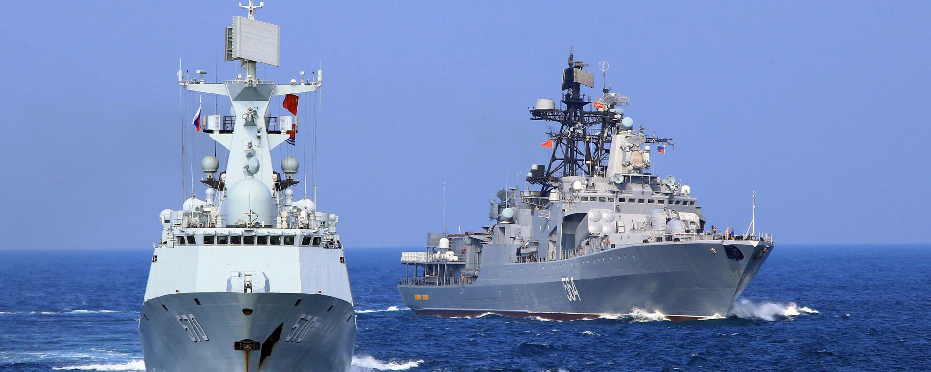 In this Friday, Sept. 16, 2016 photo released by Xinhua News Agency, Chinese Navy frigate Huangshan, left, and Russian Navy antisubmarine ship Admiral Tributs take part in a joint naval drill at sea off south China's Guangdong Province. In this Friday, Sept. 16, 2016 photo released by Xinhua News Agency, Chinese Navy frigate Huangshan, left, and Russian Navy antisubmarine ship Admiral Tributs take part in a joint naval drill at sea off south China's Guangdong Province. - Sputnik International, 1920, 12.10.2022