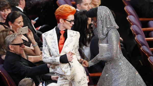 Janelle Monae signs Sandy Powell's outfit during the Oscars show at the 92nd Academy Awards in Hollywood, Los Angeles, California, U.S., February 9, 2020.  - Sputnik International