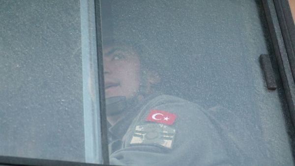 A Turkish military personnel looks out the window of a military vehicle as it enters the Bab al-Hawa crossing at the Syrian-Turkish border, in Idlib governorate, Syria, February 9, 2020 A Turkish military personnel looks out the window of a military vehicle as it enters the Bab al-Hawa crossing at the Syrian-Turkish border, in Idlib governorate, Syria, February 9, 2020 - Sputnik International
