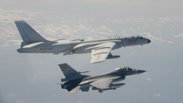 An H-6 bomber of Chinese PLA Air Force flies near a Taiwan F-16 in this February 10, 2020 handout photo provided by Taiwan Ministry of National Defense. - Sputnik International