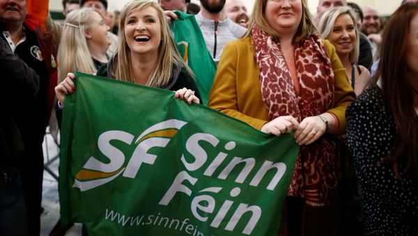Sinn Fein supporters react after exit polls were announced in Ireland's national election Sinn Fein supporters react after exit polls were announced in Ireland's national election - Sputnik International
