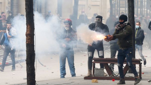 A protestor throws fireworks to the riot police during a protest seeking to prevent MPs and government officials from reaching the parliament for a vote of confidence, in Beirut, Lebanon February 11, 2020 A protestor throws fireworks to the riot police during a protest seeking to prevent MPs and government officials from reaching the parliament for a vote of confidence, in Beirut, Lebanon February 11, 2020 - Sputnik International