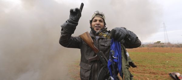 A rebel fighter holds parts of the uniform of the pilot from the Syrian government helicopter that was shot down in Idlib province A rebel fighter holds parts of the uniform of the pilot from the Syrian government helicopter that was shot down in Idlib province - Sputnik International