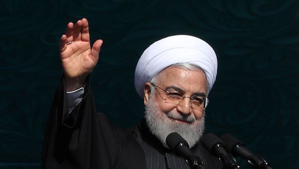 Iranian President Hassan Rouhani salutes the crowd during the commemoration of the 41st anniversary of the Islamic revolution in Tehran, Iran February 11, 2020. - Sputnik International