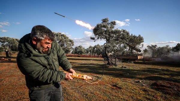 A Syrian rebel fighter remotely-fires a rocket from a truck-mounted launcher at a position in the countryside of Idlib towards regime forces positions in the southern countryside of Syria's Aleppo province on February 10, 2020.  - Sputnik International