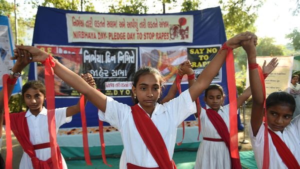 Students hold  placards during 'Nirbhaya Day' to mark the anniversary of the brutal rape case of a 23-year-old physiotherapy student on a bus in New Delhi in 2012, in Ahmedabad on December 16, 2019 - Sputnik International