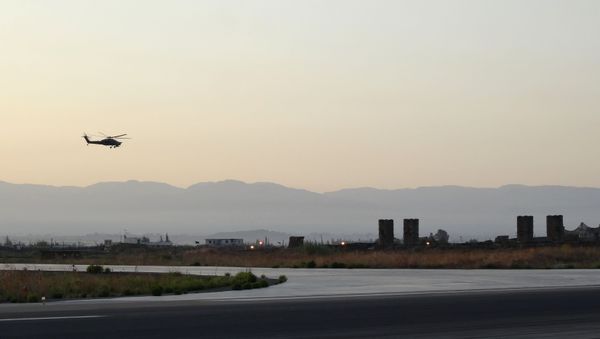 A Russian Kamov helicopter flies near S-300 missile system at the Hmeimim military base in Latakia province, in the northwest of Syria.  - Sputnik International