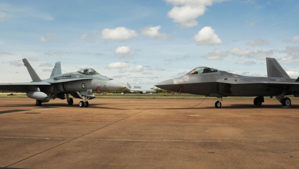 A Royal Australian Air Force E-7A Wedgetail taxies behind a RAAF 75 Squadron F/A-18A/B Hornet and U.S. Air Force 90th Fighter Squadron F-22 Raptor at RAAF Base Tindal, Australia, Feb. 24, 2017 - Sputnik International