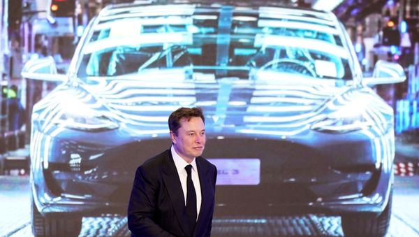 Tesla Inc CEO Elon Musk walks next to a screen showing an image of Tesla Model 3 car during an opening ceremony for Tesla China-made Model Y program in Shanghai, China January 7, 2020 - Sputnik International