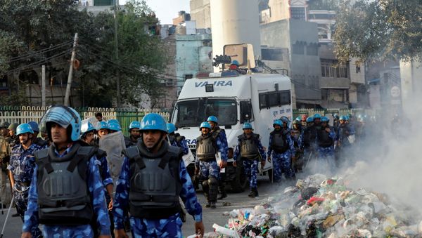 Members of Rapid Action Force (RAF) move past smoldering debris after it was set on fire by demonstrators in a riot affected area after fresh clashes erupted between people demonstrating for and against a new citizenship law in New Delhi, India, February 25, 2020. Members of Rapid Action Force (RAF) move past smoldering debris after it was set on fire by demonstrators in a riot affected area after fresh clashes erupted between people demonstrating for and against a new citizenship law in New Delhi, India, February 25, 2020. - Sputnik International