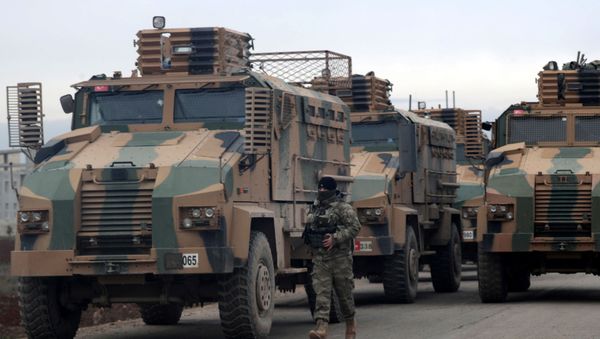 A Turkish soldier walks near Turkish military vehicles in Hazano near Idlib, Syria, February 11, 2020 - Sputnik International