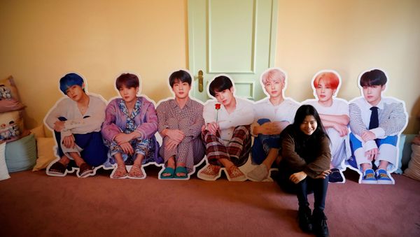 A fan of K-pop idol boy band BTS poses for photographs with cut-out of BTS at a pop-up store selling BTS goods in Seoul, South Korea, December 24, 2019. A fan of K-pop idol boy band BTS poses for photographs with cut-out of BTS at a pop-up store selling BTS goods in Seoul, South Korea, December 24, 2019. - Sputnik International