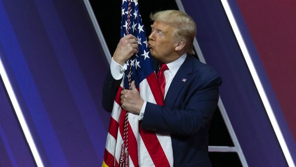 President Donald Trump kisses the American flag after speaking at Conservative Political Action Conference, CPAC 2020, at the National Harbor in Oxon Hill, Md., Saturday, Feb. 29, 2020. - Sputnik International
