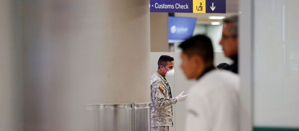 A soldier wears a surgical mask at the Mariscal Sucre International Airport, after the first case of a fast-spreading new coronavirus was confirmed in the country, in Quito, Ecuador February 29, 2020. REUTERS/Daniel Tapia A soldier wears a surgical mask at the Mariscal Sucre International Airport, after the first case of a fast-spreading new coronavirus was confirmed in the country, in Quito, Ecuador February 29, 2020. REUTERS/Daniel Tapia - Sputnik International