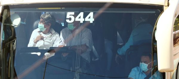 Tourists, wearing protective face masks, sit in a bus as they leave the H10 Costa Adeje Palace hotel, which is on lockdown after the novel coronavirus has been confirmed in Adeje, in the Spanish Canary Island of Tenerife, Spain, March 3, 2020 Tourists, wearing protective face masks, sit in a bus as they leave the H10 Costa Adeje Palace hotel, which is on lockdown after the novel coronavirus has been confirmed in Adeje, in the Spanish Canary Island of Tenerife, Spain, March 3, 2020 - Sputnik International