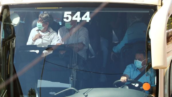 Tourists, wearing protective face masks, sit in a bus as they leave the H10 Costa Adeje Palace hotel, which is on lockdown after the novel coronavirus has been confirmed in Adeje, in the Spanish Canary Island of Tenerife, Spain, March 3, 2020 - Sputnik International