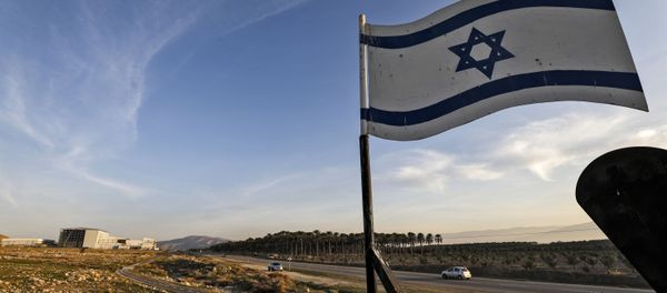 An Israeli flag hovers cars driving by the Israeli settlement of Shlomtzion in the Jordan valley in the occupied West Bank on January 27, 2020. An Israeli flag hovers cars driving by the Israeli settlement of Shlomtzion in the Jordan valley in the occupied West Bank on January 27, 2020. - Sputnik International