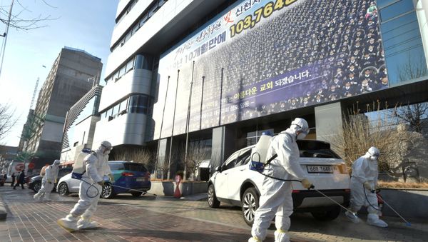 Workers from a disinfection service company sanitize a street in front of a branch of the Shincheonji Church of Jesus the Temple of the Tabernacle of the Testimony where a woman known as Patient 31 attended a service in Daegu, South Korea, February 19, 2020 - Sputnik International