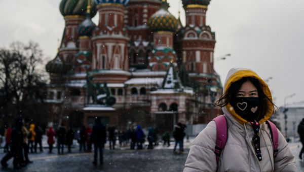 Туристка в защитной маске на Красной площади в Москве Туристка в защитной маске на Красной площади в Москве - Sputnik International