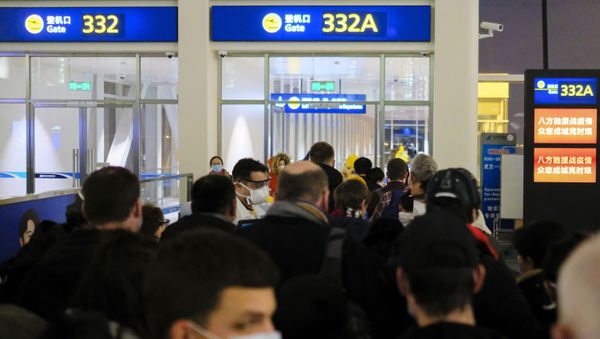 In this 2 February 2020 file photo, evacuees board an evacuation flight for EU nationals at Wuhan Tianhe International Airport in Wuhan in central China's Hubei Province. Arek and Jenina Rataj were starting a new life in the Chinese industrial centre of Wuhan when a viral outbreak spread across the city of 11 million. While they were relatively safe sheltering at home, Arek felt compelled to go out and document the outbreak of the new type of coronavirus. Among his subjects: the construction of a new hospital built in a handful of days; biosecurity check points; and empty streets. - Sputnik International