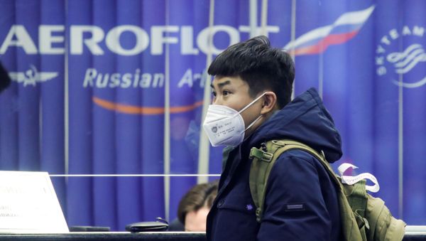 A passenger near the booking office of Russia's flagship airline Aeroflot at Sheremetyevo International Airport, Moscow - Sputnik International