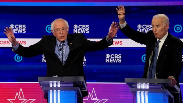 Democratic 2020 U.S. presidential candidates Senator Bernie Sanders and former Vice President Joe Biden brush hands as they have an exchange in the tenth Democratic 2020 presidential debate at the Gaillard Center in Charleston, South Carolina, U.S. February 25, 2020.  - Sputnik International