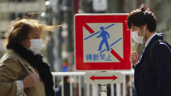 Pedestrians with protective masks on a street Thursday, 5 March 2020, in Tokyo. The number of infections of the COVID-19 disease spread around the globe. Pedestrians with protective masks on a street Thursday, 5 March 2020, in Tokyo. The number of infections of the COVID-19 disease spread around the globe. - Sputnik International