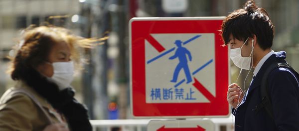 Pedestrians with protective masks on a street Thursday, 5 March 2020, in Tokyo. The number of infections of the COVID-19 disease spread around the globe. - Sputnik International