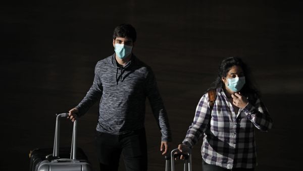 Passengers wear masks to help protect against coronavirus, at the Ben Gurion Airport near Tel Aviv, Israel, Sunday, 8 March 2020. - Sputnik International