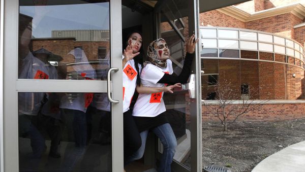 Students act during a zombie apocalypse exercise, which was to include students dressing up as the undead, on the University of Michigan campus in Ann Arbor, Mich. Tuesday April 23, 2013 - Sputnik International